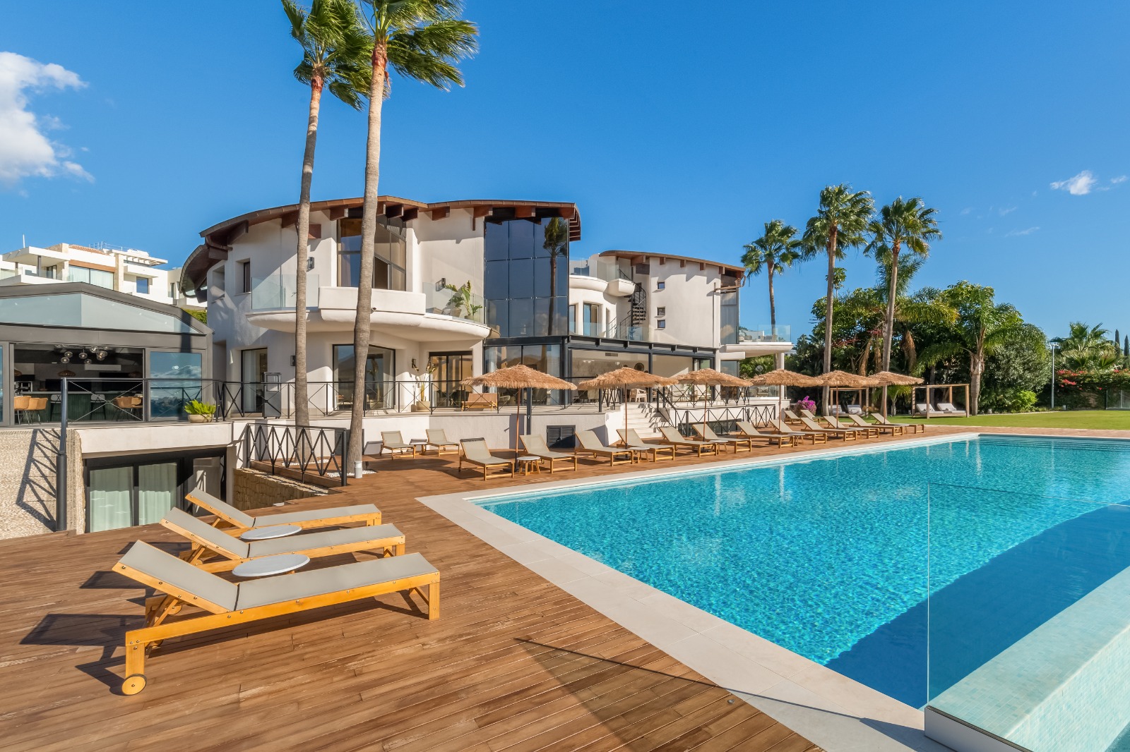 Luxury pool deck with umbrellas and loungers